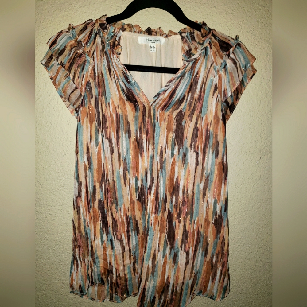 Multi colored blouse with ruffled short sleeves. Fully lined v-neck.